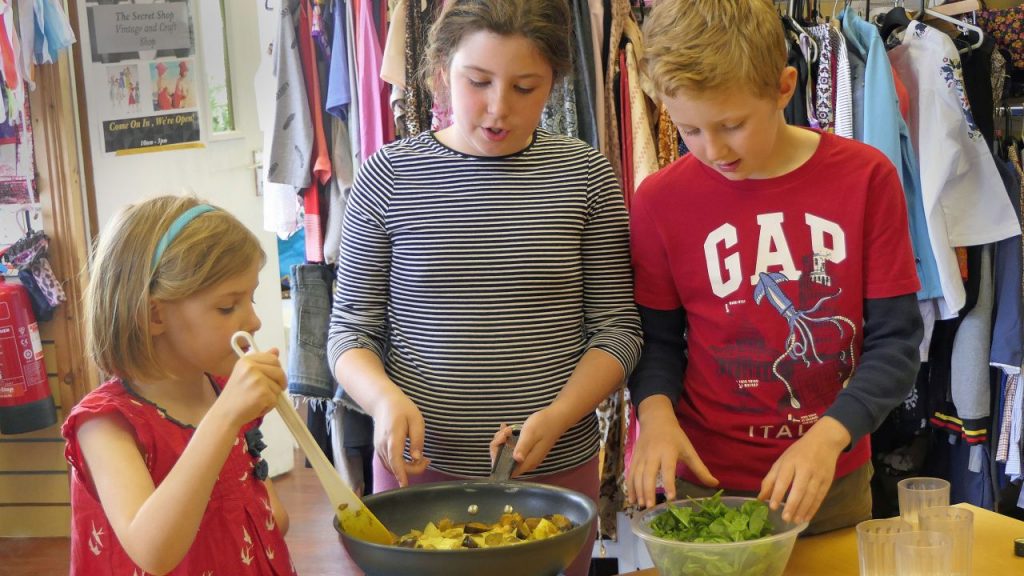 Kids adding ingredients and stirring