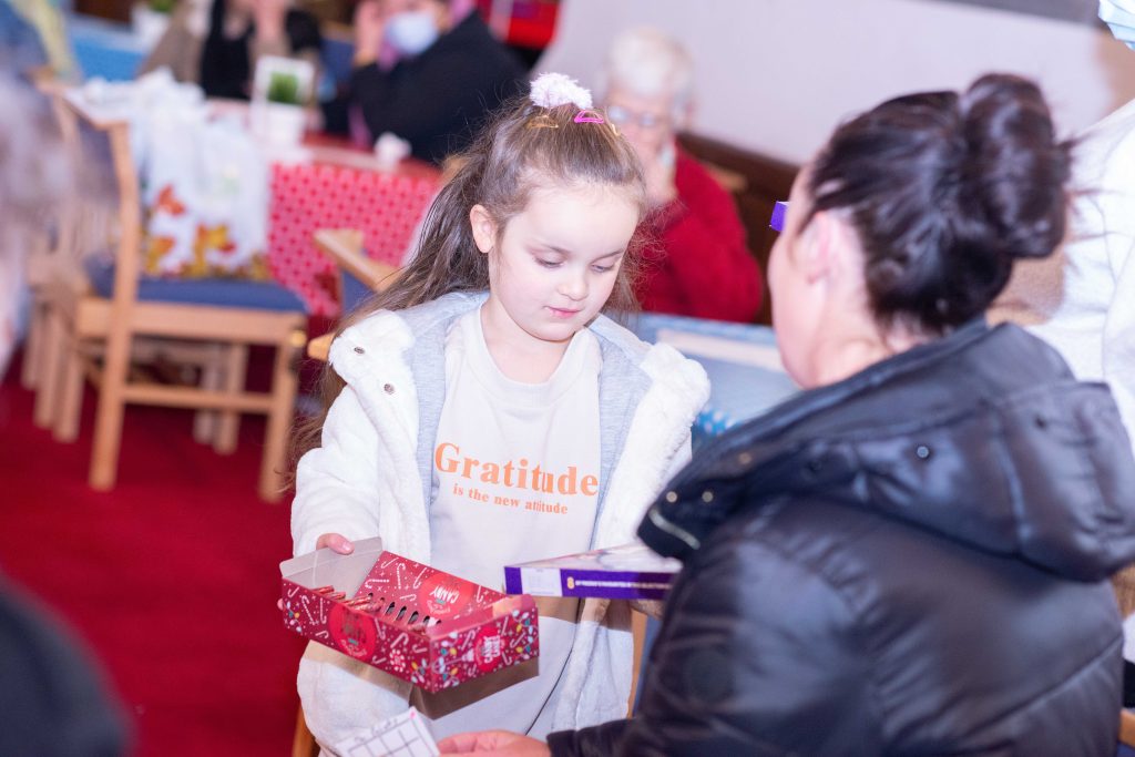 Child receiving Christmas chocolate treat