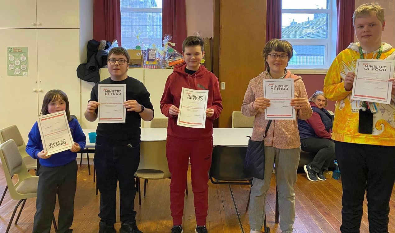 A group of children holding certificates