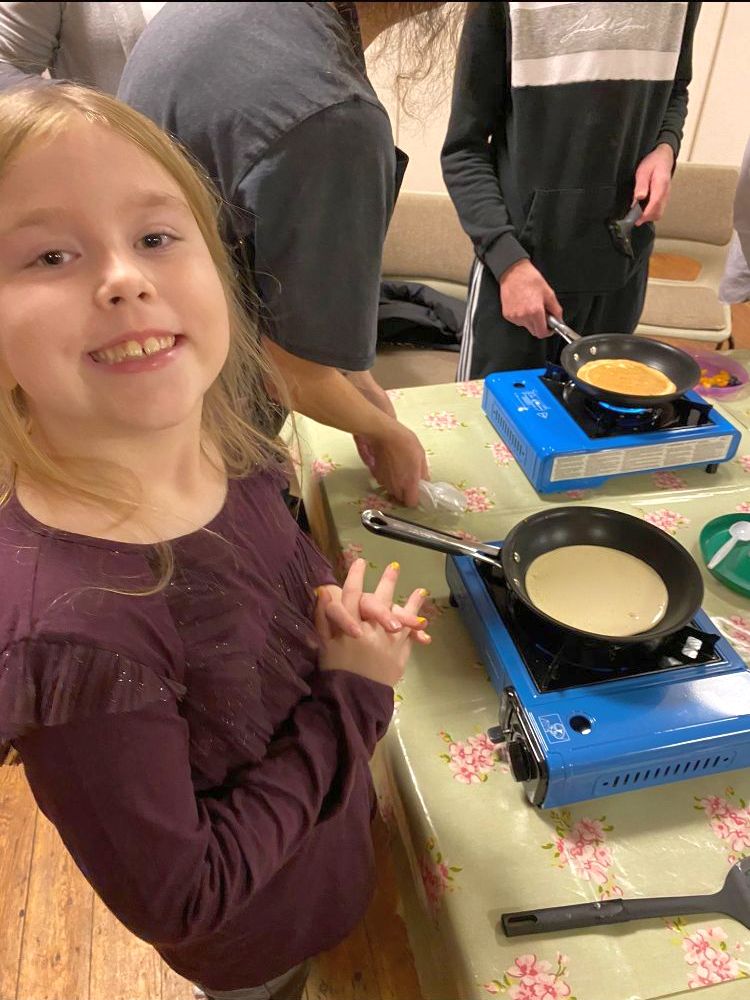 Girl cooking a pancake