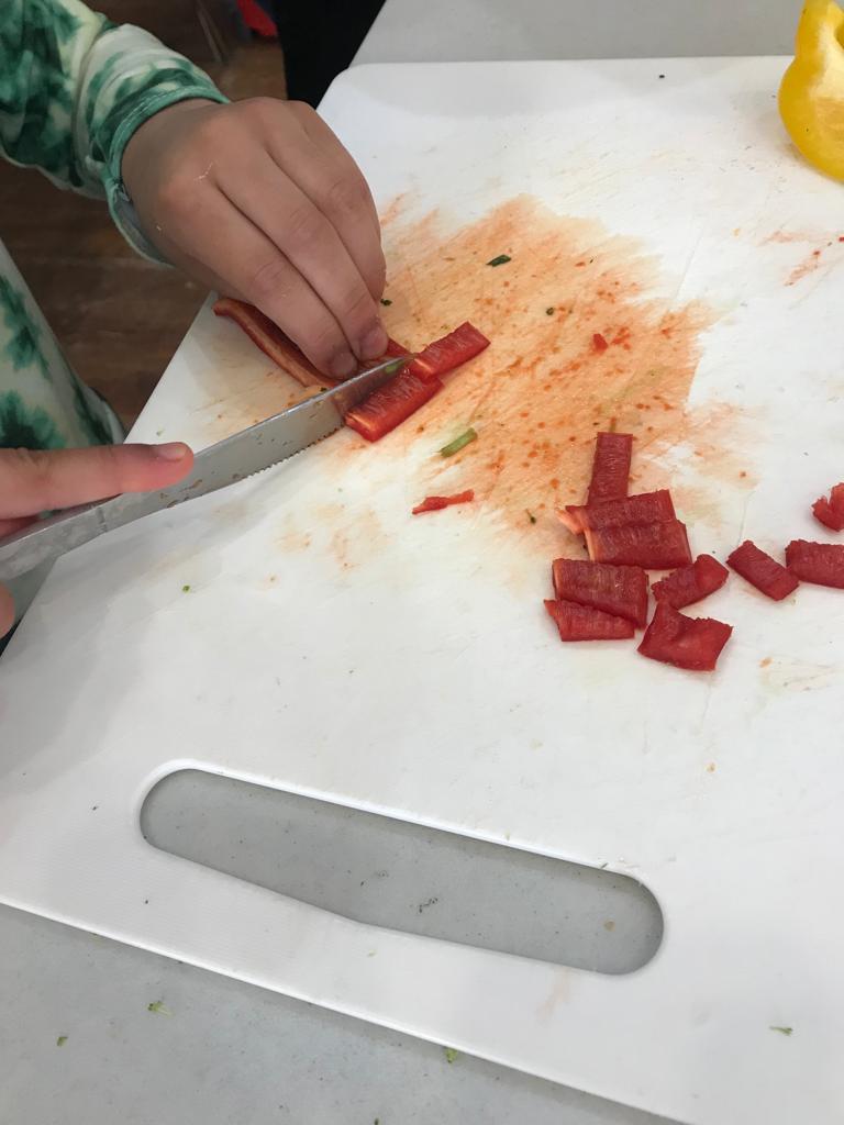 Child chopping peppers