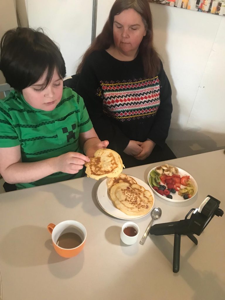 Boy about to eat a pancake he has made