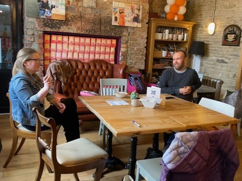 Two people talking at a table