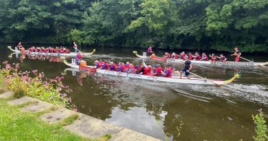 Three dragon boats racing on the river