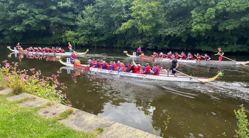 Three dragon boats racing on the river