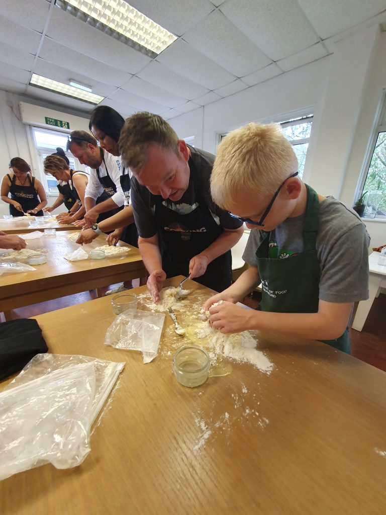 A pair of cooks mix pasta dough