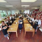 A group of cooks show off their pasta dishes