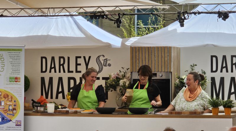 Three chefs demonstrating a recipe in Darley Street Market