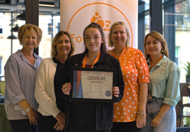 Members of the FoodSavers team hold a certificate recognising official accreditation by Stop Loan Sharks