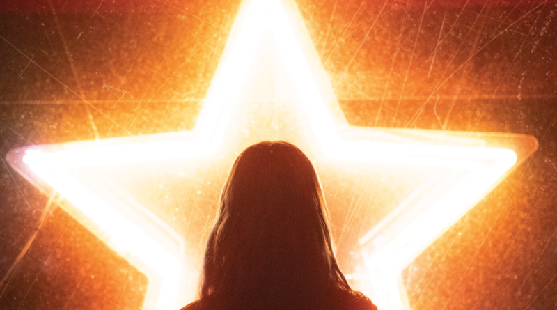 Silhouette of a woman in front of a neon star